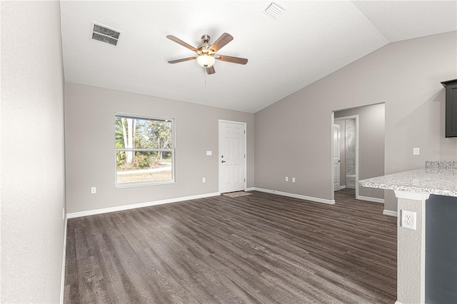 unfurnished living room with ceiling fan, lofted ceiling, and dark hardwood / wood-style flooring