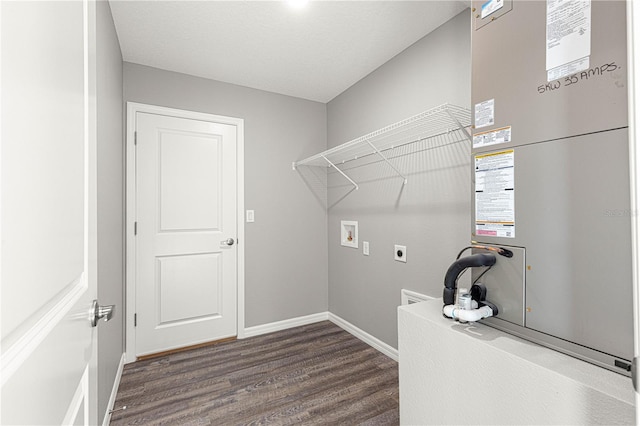 clothes washing area with dark hardwood / wood-style floors, washer hookup, hookup for an electric dryer, and heating unit