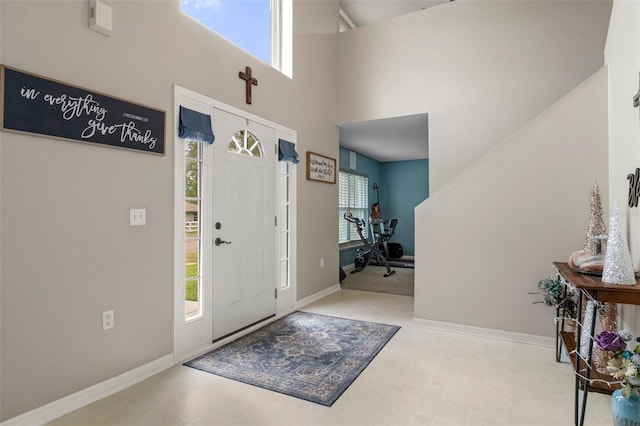 entryway featuring a towering ceiling