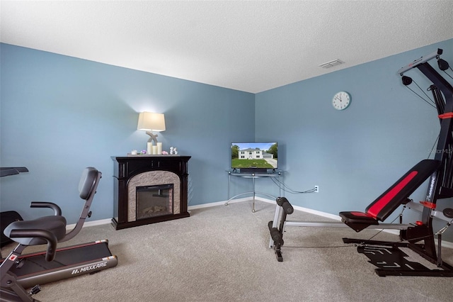 interior space featuring a textured ceiling and carpet flooring