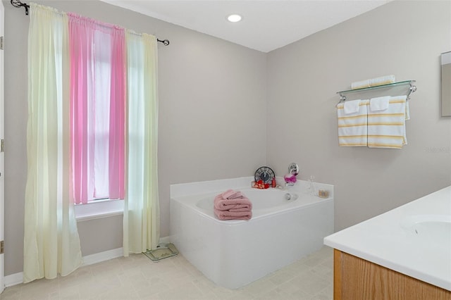 bathroom featuring vanity and a washtub