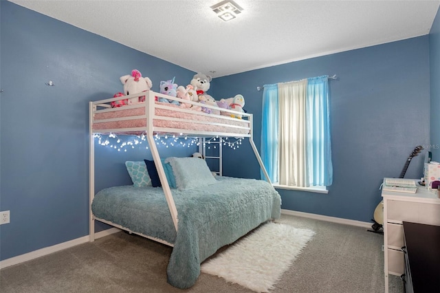 carpeted bedroom featuring multiple windows and a textured ceiling