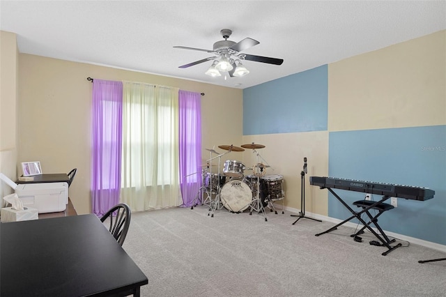 interior space with a wealth of natural light, ceiling fan, and light carpet