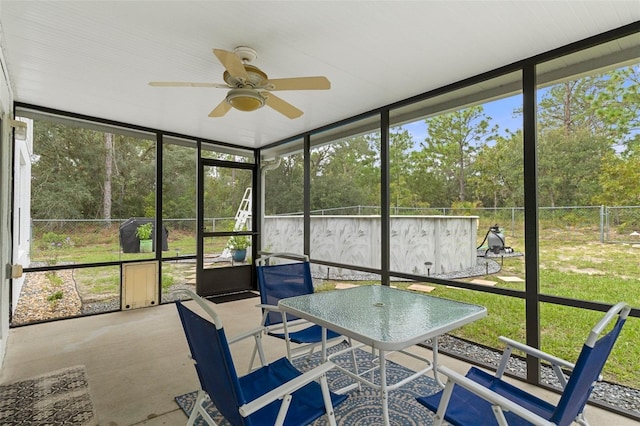 unfurnished sunroom with a healthy amount of sunlight and ceiling fan