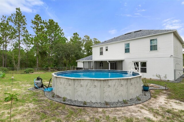 view of pool featuring a lawn