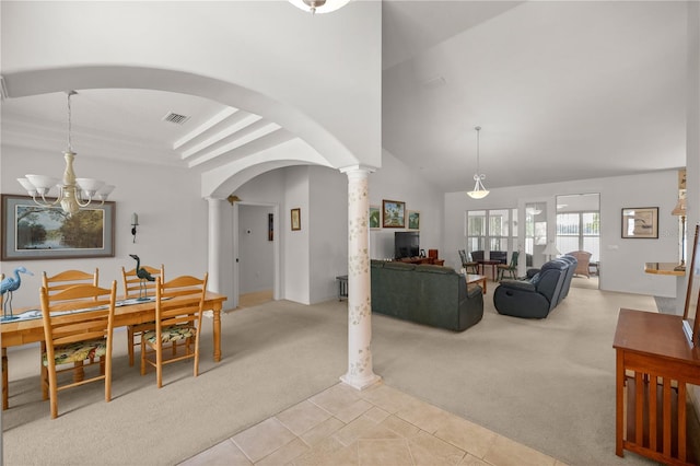 living room with light colored carpet, a notable chandelier, and decorative columns