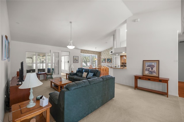 living room featuring lofted ceiling and light colored carpet