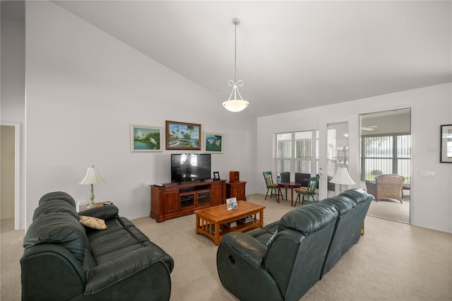 living room featuring high vaulted ceiling and light colored carpet