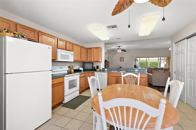 kitchen featuring ceiling fan, white appliances, kitchen peninsula, and light tile patterned flooring