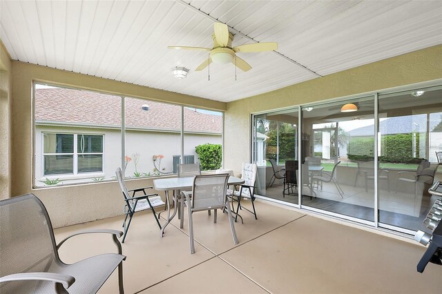 sunroom / solarium featuring ceiling fan