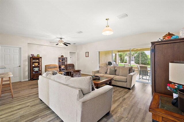 living room with dark wood-type flooring and ceiling fan