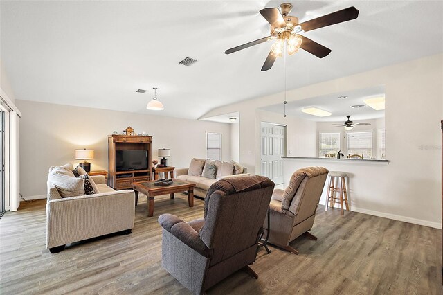 living room featuring light wood-type flooring and ceiling fan