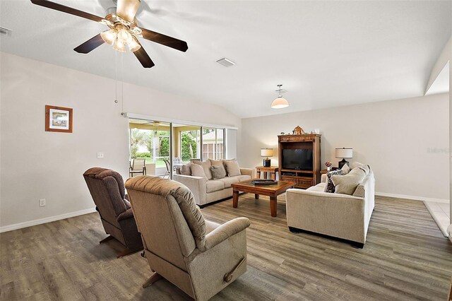 living room with vaulted ceiling, dark hardwood / wood-style flooring, and ceiling fan