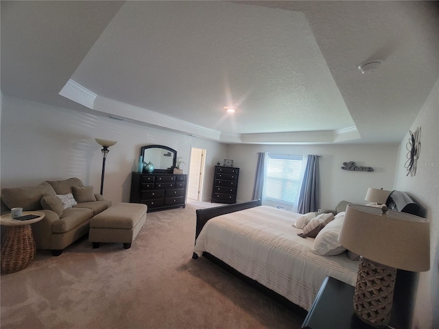 carpeted bedroom with a textured ceiling, ornamental molding, and a tray ceiling