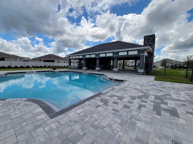 pool featuring a patio area and fence