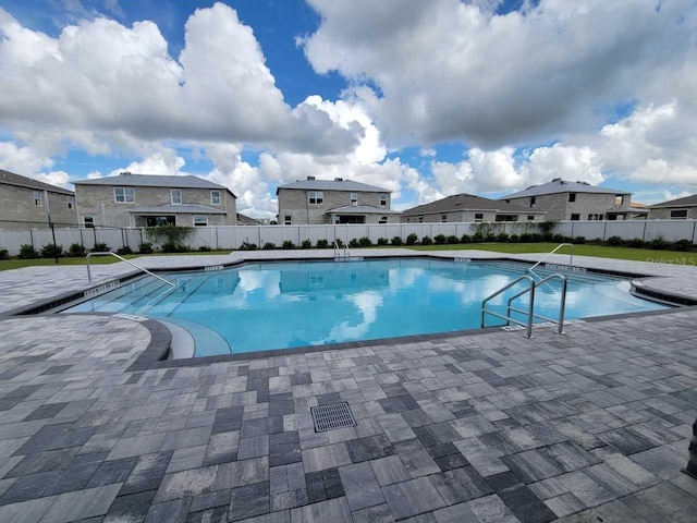 view of swimming pool with a patio, fence, and a fenced in pool