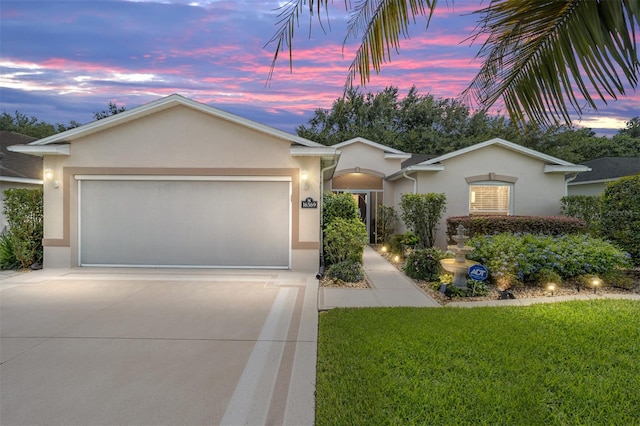 ranch-style house with a lawn and a garage