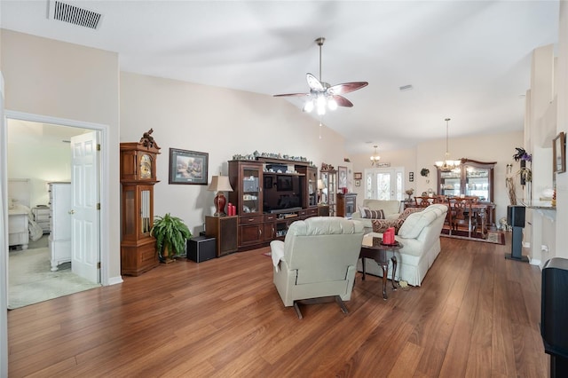 living room featuring high vaulted ceiling, ceiling fan with notable chandelier, and hardwood / wood-style flooring