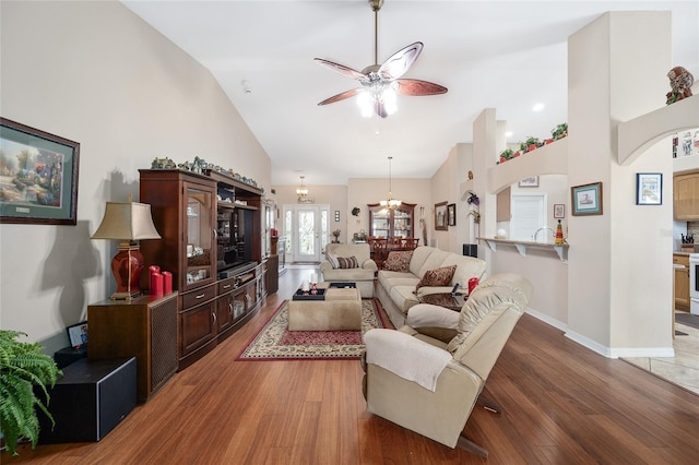 living room featuring ceiling fan, hardwood / wood-style floors, and high vaulted ceiling