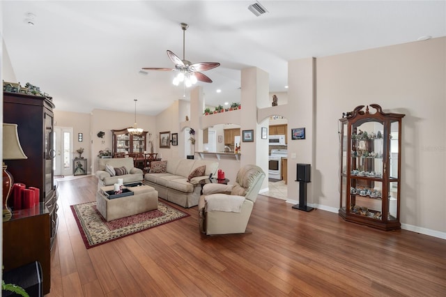 living room with ceiling fan and dark hardwood / wood-style flooring