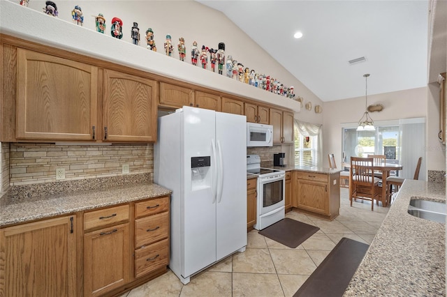 kitchen featuring pendant lighting, vaulted ceiling, white appliances, and decorative backsplash