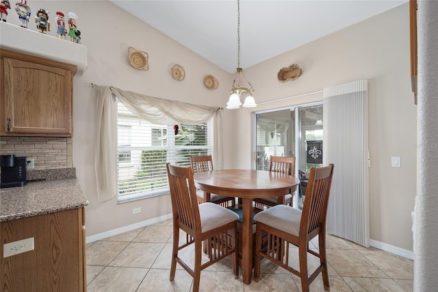 dining room featuring lofted ceiling, an inviting chandelier, and light tile patterned floors