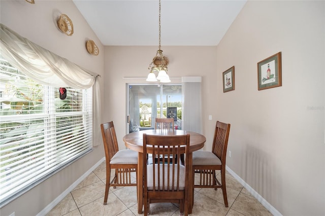 dining space with an inviting chandelier and light tile patterned flooring