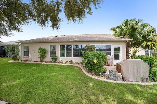 rear view of property with a yard