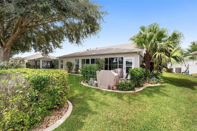 16369 SW 14th Avenue Rd, Ocala, FL 34473 - back of house with central AC, a yard, and stucco siding