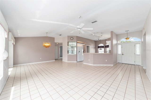 unfurnished living room featuring ceiling fan with notable chandelier, light tile patterned flooring, and vaulted ceiling