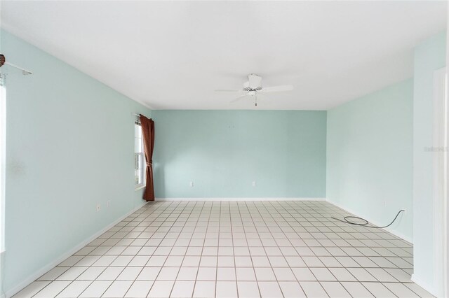 unfurnished room with ceiling fan and light tile patterned flooring