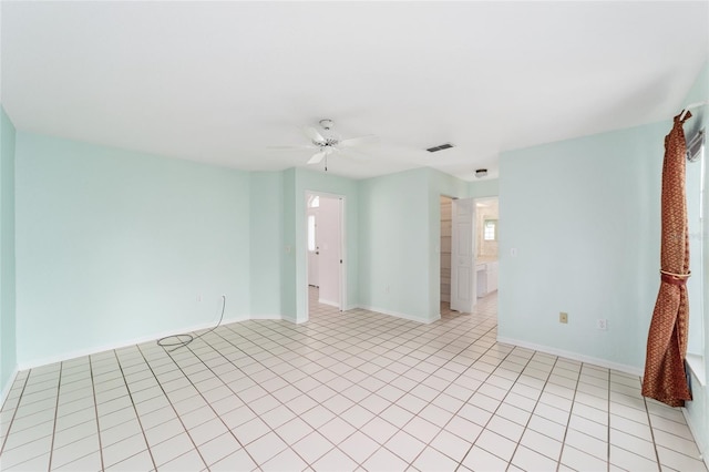 tiled spare room with ceiling fan