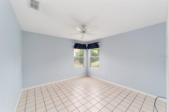 tiled spare room with ceiling fan