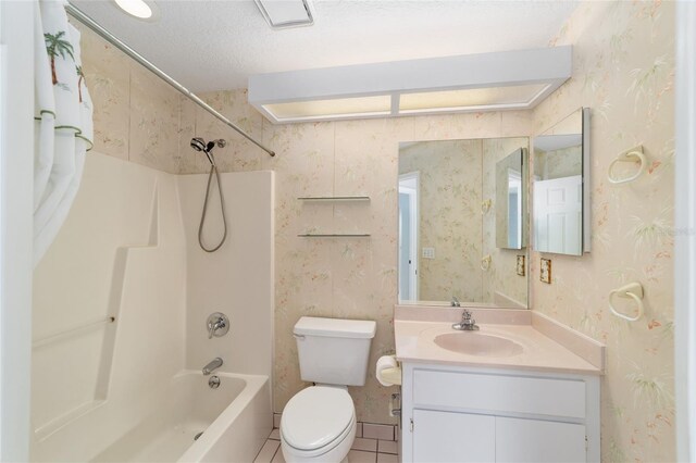 full bathroom featuring toilet, tile patterned flooring, vanity, a textured ceiling, and shower / bath combination