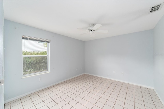 spare room with ceiling fan and light tile patterned flooring