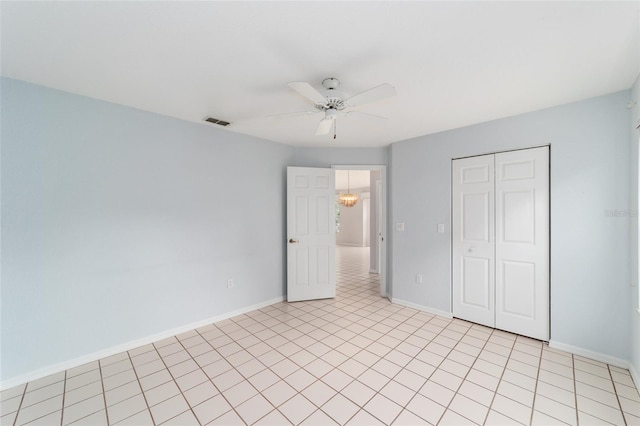 unfurnished bedroom featuring light tile patterned floors, ceiling fan, and a closet