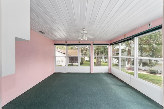 unfurnished sunroom featuring a healthy amount of sunlight and ceiling fan