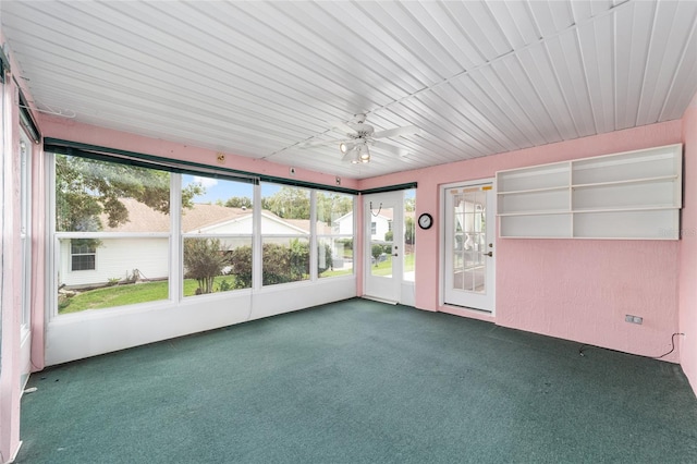 unfurnished sunroom with a wealth of natural light and ceiling fan