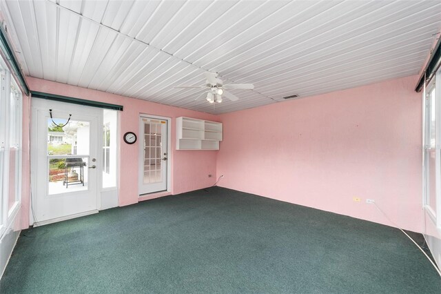 unfurnished sunroom with ceiling fan