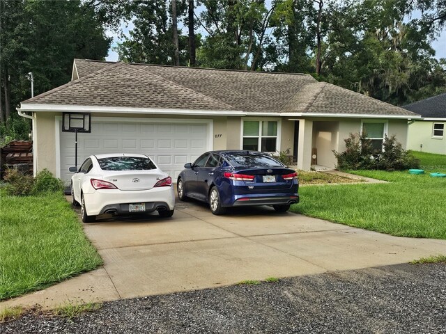 ranch-style house with a garage and a front lawn