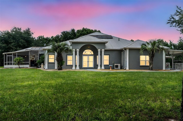 ranch-style home with a yard