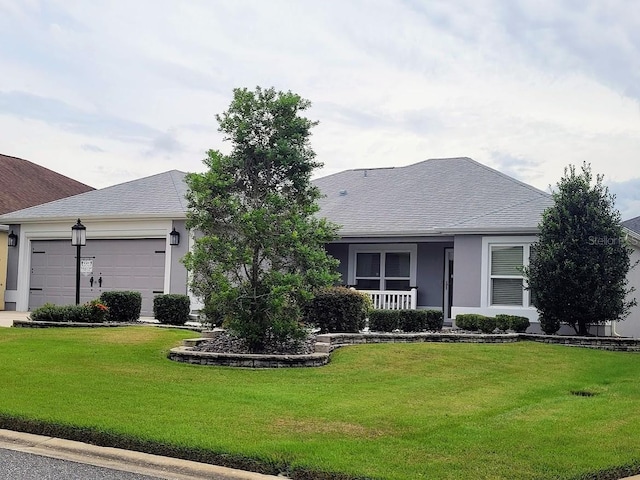 ranch-style home with a front yard and a garage