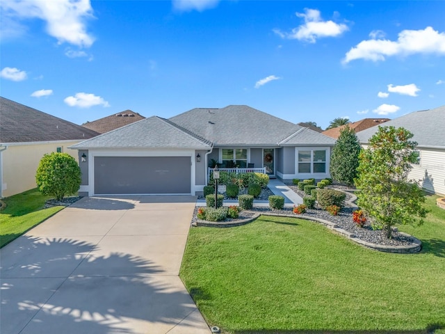 ranch-style home with a front yard, a garage, and a porch