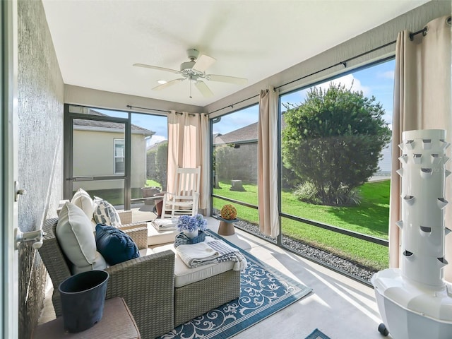 sunroom / solarium with a healthy amount of sunlight and ceiling fan