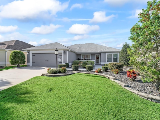 single story home featuring a garage and a front lawn