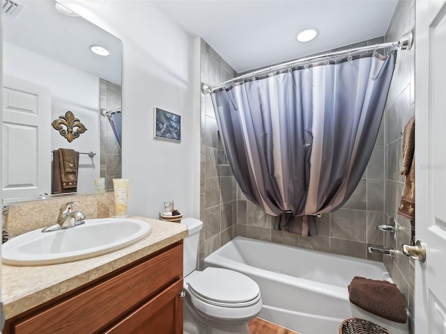 full bathroom featuring shower / tub combo with curtain, vanity, and toilet