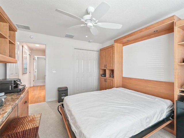 bedroom with ceiling fan, a closet, and light carpet