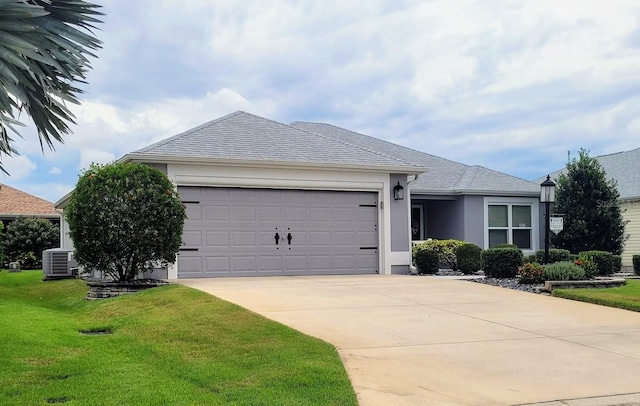 ranch-style house featuring cooling unit, a front lawn, and a garage