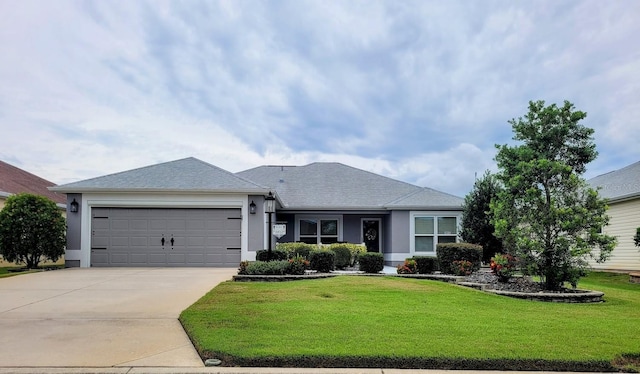 single story home featuring a garage and a front lawn