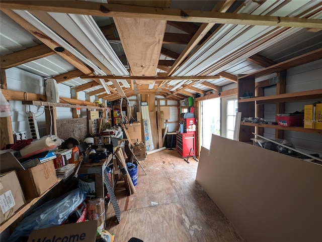 basement with light wood-type flooring and wooden walls